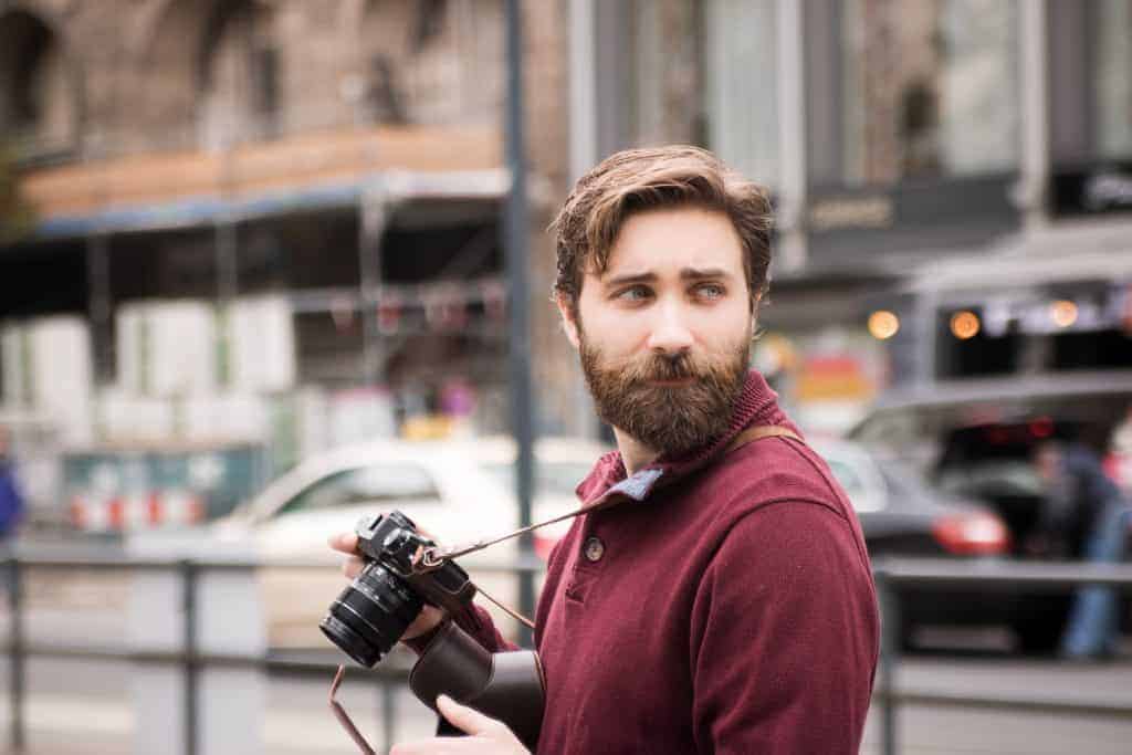 Man with beard and camera in the city