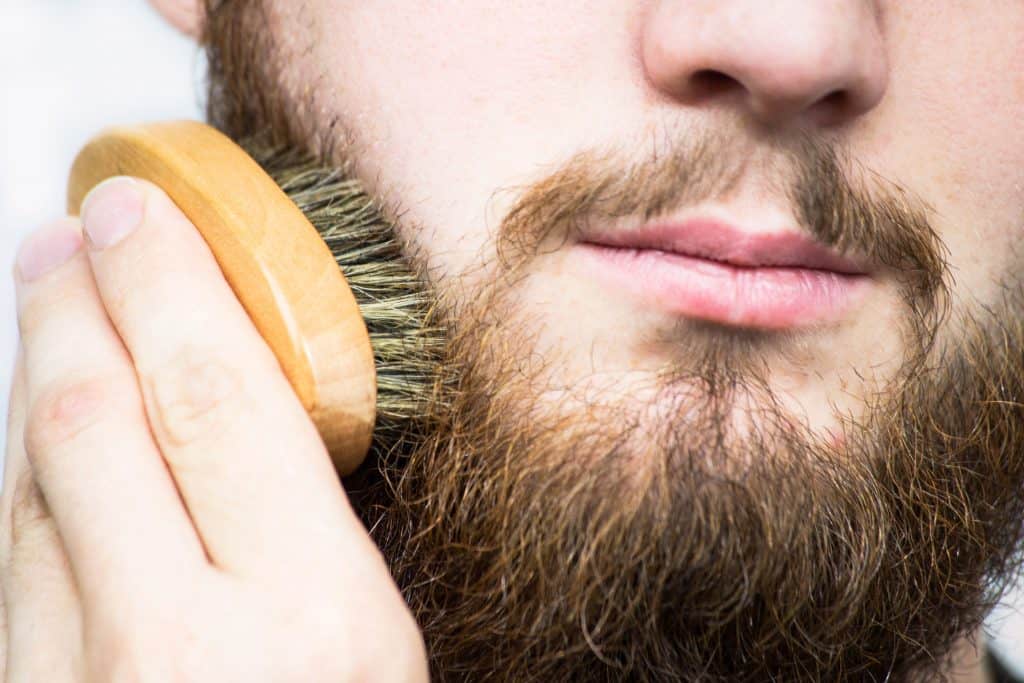 Man brushes beard